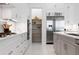 Bright kitchen features stainless steel appliances, modern cabinetry and a convenient pantry at 624 Blue Shell Loop, Sarasota, FL 34240