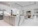 Open-concept kitchen with a marble island and a view into the living room and dining area at 624 Blue Shell Loop, Sarasota, FL 34240