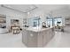 Bright kitchen with a marble island that views into the dining and living room at 624 Blue Shell Loop, Sarasota, FL 34240