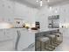 Modern kitchen with white cabinets, waterfall island countertop, and stainless steel appliances at 624 Blue Shell Loop, Sarasota, FL 34240