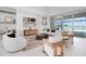 Airy living space with modern decor, neutral tones, and a view to the pool area through sliding glass doors at 624 Blue Shell Loop, Sarasota, FL 34240