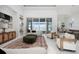 Spacious living room featuring stylish decor, large windows with pool views, and elegant recessed lighting at 624 Blue Shell Loop, Sarasota, FL 34240