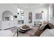 Bright living room with neutral tones, stylish furniture, and large sliding glass doors at 624 Blue Shell Loop, Sarasota, FL 34240