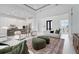 Open-concept living room featuring a modern kitchen, stylish furnishings, and a bright, airy atmosphere at 624 Blue Shell Loop, Sarasota, FL 34240
