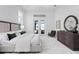 Bright main bedroom featuring neutral tones, tray ceilings, and sliding doors to an outdoor patio at 624 Blue Shell Loop, Sarasota, FL 34240