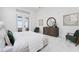 Bright main bedroom featuring neutral tones, tray ceilings, and sliding doors to an outdoor patio at 624 Blue Shell Loop, Sarasota, FL 34240
