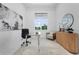 Bright office space featuring a glass desk, modern art, and natural light from a large window with views at 624 Blue Shell Loop, Sarasota, FL 34240