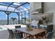 Outdoor kitchen and dining area with a grill, fridge, and lake views at 624 Blue Shell Loop, Sarasota, FL 34240
