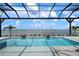 Sparkling pool under a screened enclosure offering stunning water views at 624 Blue Shell Loop, Sarasota, FL 34240