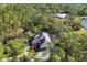 Stunning aerial view of home, pool, and lush wooded surroundings at 6700 S Gator Creek Blvd, Sarasota, FL 34241