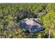 Aerial view showcasing house nestled in the woods at 6700 S Gator Creek Blvd, Sarasota, FL 34241