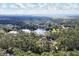 Aerial view of a house nestled in a lush, wooded area near a lake at 6700 S Gator Creek Blvd, Sarasota, FL 34241