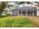 Spacious backyard with screened enclosure and lush landscaping at 6700 S Gator Creek Blvd, Sarasota, FL 34241