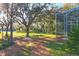 Landscaped backyard with mature trees and privacy at 6700 S Gator Creek Blvd, Sarasota, FL 34241