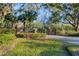Gated entrance to the community with lush landscaping and brick pillars at 6700 S Gator Creek Blvd, Sarasota, FL 34241