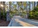 Private gated entrance with stone pillars leading to a paved driveway at 6700 S Gator Creek Blvd, Sarasota, FL 34241