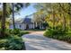 Beautiful home with a long driveway and mature landscaping at 6700 S Gator Creek Blvd, Sarasota, FL 34241