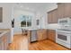 Bright kitchen with breakfast nook, hardwood floors, and ample cabinetry at 6700 S Gator Creek Blvd, Sarasota, FL 34241