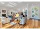 Bright and airy living room with hardwood floors and access to outdoor spaces at 6700 S Gator Creek Blvd, Sarasota, FL 34241