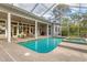 Screened-in pool and spa with patio seating at 6700 S Gator Creek Blvd, Sarasota, FL 34241