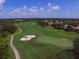 Stunning aerial view of golf course with sand traps and residential homes at 6847 Bay Hill Dr, Lakewood Ranch, FL 34202