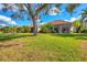 Landscaped backyard, spacious grassy area, home view at 6847 Bay Hill Dr, Lakewood Ranch, FL 34202