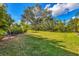 Large backyard with lush grass and mature trees at 6847 Bay Hill Dr, Lakewood Ranch, FL 34202