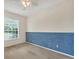 Light and airy bedroom with blue accent wall at 6847 Bay Hill Dr, Lakewood Ranch, FL 34202
