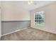 Simple bedroom with gray accent wall and carpet at 6847 Bay Hill Dr, Lakewood Ranch, FL 34202