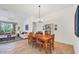 Bright dining room with a wooden table and access to the living area at 6847 Bay Hill Dr, Lakewood Ranch, FL 34202