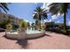 Charming circular fountain with decorative urns, surrounded by brick pavement at 6847 Bay Hill Dr, Lakewood Ranch, FL 34202
