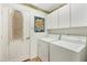 Laundry room with washer, dryer, and cabinets at 6847 Bay Hill Dr, Lakewood Ranch, FL 34202