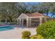 Community pool area with covered patio and grill at 6847 Bay Hill Dr, Lakewood Ranch, FL 34202