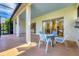Enjoy this screened patio with table and chairs; view of the backyard at 6847 Bay Hill Dr, Lakewood Ranch, FL 34202