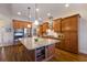 Modern kitchen with stainless steel appliances, granite countertops, and a large island at 7115 Callander Cv, Lakewood Ranch, FL 34202