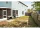 View of the backyard with a partial fence, grass, patio, and the exterior of the house at 731 Cristelle Jean Dr, Ruskin, FL 33570