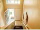 View of the entryway, with tiled floor, white front door, and stairs leading to the upper level at 731 Cristelle Jean Dr, Ruskin, FL 33570