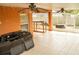 Covered tile patio with ceiling fans and outdoor storage, perfect for entertaining at 731 Cristelle Jean Dr, Ruskin, FL 33570
