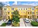 Townhouse community with yellow buildings and parking at 7325 Black Walnut Way, Lakewood Ranch, FL 34202