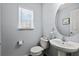 Small half bathroom with pedestal sink and toilet at 7325 Black Walnut Way, Lakewood Ranch, FL 34202