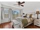 Bright bedroom with a comfortable bed and access to a balcony at 7325 Black Walnut Way, Lakewood Ranch, FL 34202