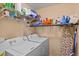 Well-equipped laundry room with washer, dryer, and shelving at 7325 Black Walnut Way, Lakewood Ranch, FL 34202