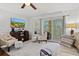 Bright living room with comfortable seating and access to balcony at 7325 Black Walnut Way, Lakewood Ranch, FL 34202