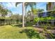 Private backyard with lush landscaping and screened patio at 7664 Plantation Cir, Bradenton, FL 34201