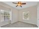 Bright bedroom with neutral carpeting and two large windows at 7664 Plantation Cir, Bradenton, FL 34201