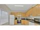 Kitchen boasts light wood cabinets, granite counters, and stainless steel appliances at 7664 Plantation Cir, Bradenton, FL 34201