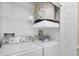 Laundry closet with stackable washer and dryer, and shelving at 7664 Plantation Cir, Bradenton, FL 34201