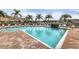 Community swimming pool with brick patio at 7664 Plantation Cir, Bradenton, FL 34201