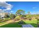 Partial view of the community landscape with lush lawn and tropical plants at 7840 34Th W Ave # 203, Bradenton, FL 34209