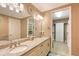 Bathroom with double vanity, granite countertop, and walk-in closet at 7840 34Th W Ave # 203, Bradenton, FL 34209
